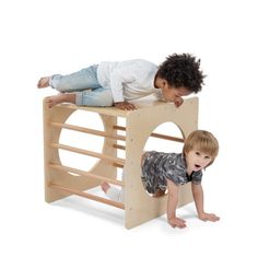 two children playing on a wooden play structure