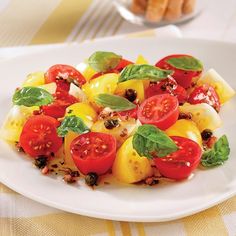 a white plate topped with fruit and veggies on top of a yellow table cloth