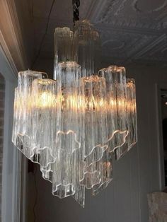 a chandelier hanging from the ceiling in a room