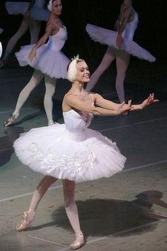 ballerinas in white tutus and tiaras on stage