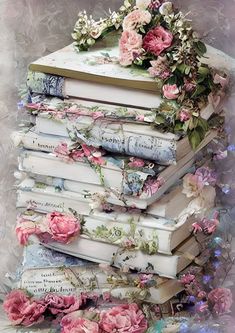 a stack of books with pink flowers on top of each book is surrounded by other books