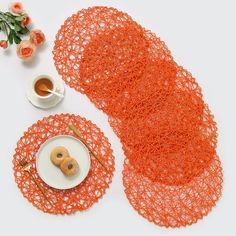 two plates with donuts on them next to an orange doily