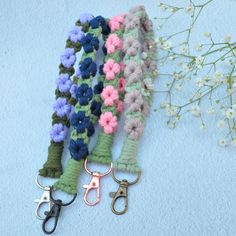 several crocheted flowers and scissors on a blue surface