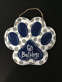 a blue and white dog paw ornament with the words go bulldogs on it