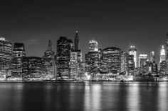 black and white photo of the city skyline at night