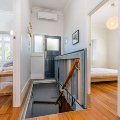 an open door leading to a bedroom with hardwood floors