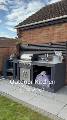 an outdoor kitchen with bbq and grill