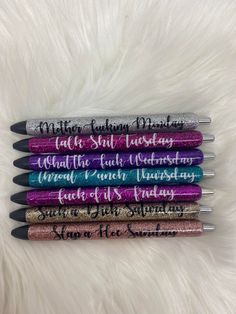 four pens with writing on them sitting next to each other