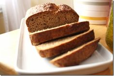 slices of bread on a white plate next to a cup