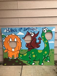 a wooden sign with an image of two dinosaurs on it