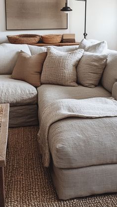 a living room with a sectional couch and coffee table