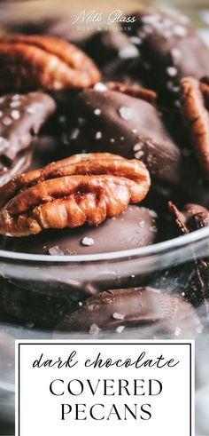 chocolate covered pecans in a glass bowl with the words dark chocolate covered pecans