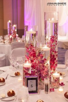 the centerpieces are filled with flowers and candles