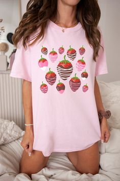 Get ready to be OBSESSED with your new favourite strawberry shirt! This classic cottagecore shirt fits like a well-loved favourite, you'll want to wear it all the time. Made of heavy cotton, it's cozy and cute, you'll fall in love with it over and over again. Mmm, chocolate covered strawberries!  Additional details: .: 100% Cotton .: Medium fabric .: Classic fit .: Runs bigger than usual *SIZING* Available in S, M, L, 2XL, 3XL (please keep in mind these are unisex sizes).  *COLORS* Available in: Sweet Strawberry Print Crew Neck Top, Sweet Short Sleeve Tops With Fruit Print, Sweet Short Sleeve Cotton Shirt, Sweet Cotton Tops With Fruit Print, Cute Strawberry Print Shirt, Cute Strawberry Print Crew Neck Shirt, Sweet Strawberry Print Short Sleeve T-shirt, Sweet Pink T-shirt With Strawberry Print, Cute Crew Neck Shirt With Strawberry Print