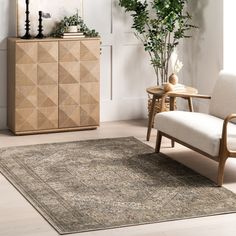 a living room with a chair, rug and plant on the sideboard in front of it