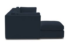 a blue couch and footstool sitting next to each other on a white background