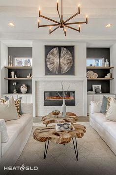 a living room with two couches and a coffee table in front of a fireplace