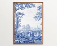 a blue and white painting hanging on the wall