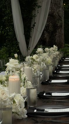 a long table with candles and flowers on it