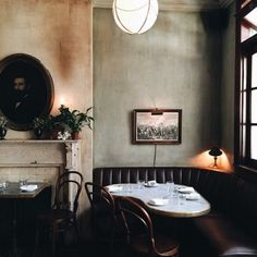 a dining room with tables and chairs in front of a fireplace