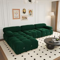 a green couch sitting on top of a white rug in a living room next to a table