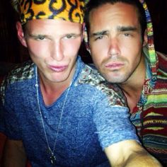 two men are posing for the camera with their heads covered in bandana's