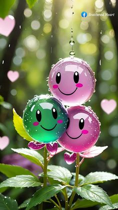 two water balloons with faces on them are in the air and have hearts hanging from them