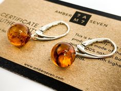 Stylish and unique handmade amber sphere earrings. Made of 100% natural organic Baltic Amber. As amber is an all-natural gemstone, every earring is unique that's why every piece of jewelry is one of the kind. Earrings already come in gift-ready packaging made of only eco recycled materials. AMBER COLOR Cognac / Butterscotch AMBER FINISH Polished MATERIAL Baltic amber, 925 sterling silver LENGHT ~ 3 cm / 1.2 inch STONE LENGHT ~ 1 cm / 0.4 inch WIDTH ~ 1 cm / 0.4 inch Cheap Amber Drop Earrings, Cheap Handmade Amber Earrings, Elegant Amber Round Bead Earrings, Amber Sterling Silver Hypoallergenic Earrings, Hypoallergenic Amber Sterling Silver Earrings, Hypoallergenic Sterling Silver Amber Earrings, Cabochon Amber Earrings For Gift, Amber Cabochon Earrings Gift, Amber Cabochon Earrings For Gifts