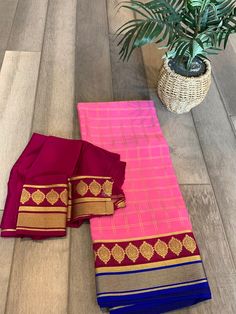 Very lovely color combo with this rich Mysore Silk saree. The saree is pure silk and silk mark certified. Comes with a rich pallu in maroon and a beautiful contrast border to the rosy pink body. The saree is in trendy checks and gives a grand look after draping. Saree comes with a blouse piece in the same color as pallu. Falls and pico is done and saree is ready to wear. Custom Blouse stitching can be done at an additional price. Note that providing accurate measurements for blouse stitching is Traditional Pink Blouse Piece With Border, Pink Semi-stitched Pre-draped Saree With Border, Pink Saree Sets With Printed Border, Pink Traditional Wear With Border For Puja, Bollywood Style Pre-draped Saree With Border For Traditional Ceremonies, Bollywood Style Pink Pre-draped Saree With Border, Bollywood Style Pink Churidar For Traditional Ceremonies, Pink Pre-draped Saree With Border For Festivals, Pink Bollywood Churidar For Traditional Ceremonies