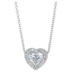 Lovely 1.22ct Diamonds Heart-Shaped Halo Necklace in 18k White Gold - GIA Certified Dazzle with sophistication and charm wearing this exquisite diamond halo necklace. Crafted in luxurious 18k white gold, the centerpiece boasts a stunning 1.00-carat heart-shaped diamond, radiating unmatched brilliance. Complementing this are 20 round side diamonds totaling 0.22-carat, adding a brilliant touch to this elegant piece. Certified by GIA, this necklace assures superior quality and exceptional craftsman Halo Necklace, Heart Shaped Diamond, Diamond Halo, Diamond Heart, Halo Diamond, Diamond White, Jewelry Necklace Pendant, Halo, Heart Shapes