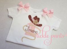 --♥♥-- Your birthday top will be embroidered with your girl's birthday number in pink fabric, fabric pattern will vary. The number will be wearing a cowgirl hat and birthday girl's name will be embroidered through the number. Matching bows will be sewn to each shoulder. SIZING:Bodysuits are Carter's brand and smaller and are available in sizes 3m, 6m, 9m, 12m, 18m, 24m.Shirts are specific for embroidery and run true to size. Available sizes 2T, 3T, 4T, 5, 6 and 8. There is no size 7.CARE INSTRUC Personalized Fitted Pink Tops, First Rodeo Birthday Party Girl Outfit, Embroidered Pink Tops For Birthday, Pink Embroidered Top For Birthday, Pink Embroidered Top For Birthday Party, This Aint My First Rodeo Girl, One Year Old Cowgirl Outfit, My First Rodeo Birthday Shirt, Not My First Rodeo Shirt