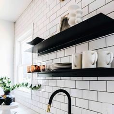 black and white kitchen shelves with coffee mugs on them