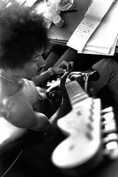 a young child is playing with an electric guitar