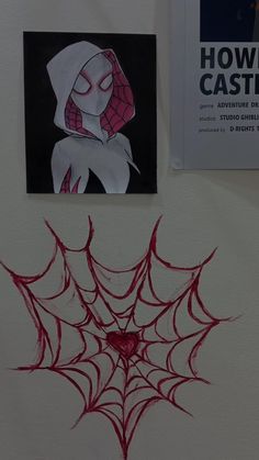 a spider - man drawn on the wall next to a drawing of a woman's face