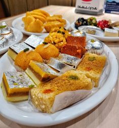 a plate full of different types of food sitting on a table next to a box of chips