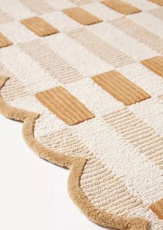 a close up of a rug on the floor with squares and lines in it,