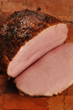 sliced ham sitting on top of a wooden cutting board