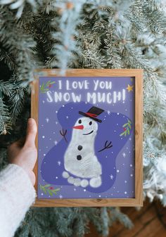 someone is holding up a card with a snowman on it that says i love you, snow much