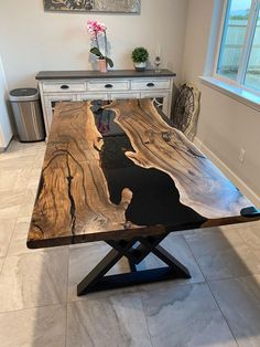 a wooden table sitting on top of a tiled floor