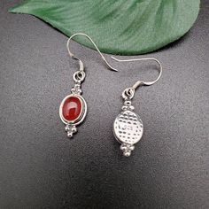 Visit our on-line shop at: Etsy.com/shop/AlbuquerqueDesigns *sterling silver earrings with stone *dangles / drops / hooks / earwires *southwestern jewelry *carnelian / healing carnelian *calibrated pre-cut stones: 9x7mm oval shape *back of jewelry items are all covered / do not show the back of stones *all jewelry items are made to ship, slight variations in stones will occur comparing to pictures. *size of a penny is 19mm or a dime is 18mm in diameter for comparing size with jewelry items. *han Nickel-free Carnelian Jewelry, Silver Carnelian Jewelry With Ear Wire, Silver Carnelian Drop Earrings, Silver Carnelian Earrings, Silver Round Carnelian Earrings, Silver Carnelian Earrings For Gift, Carnelian Earrings, Carnelian Necklace, Southwestern Jewelry