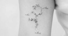 a woman's arm with flowers on it and the word love written in cursive