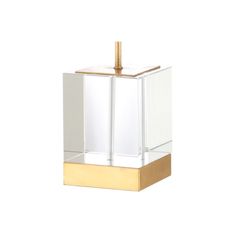 a gold and clear glass box with a golden handle on it's side, against a white background