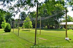 a baseball cage in the middle of a yard