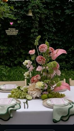 the table is set with plates and flowers