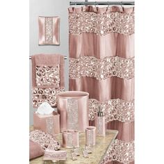 a bathroom with pink and gold decor on the shower curtain, toilet paper roll, soap dispenser