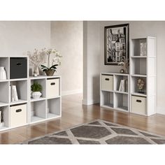 a living room filled with lots of white shelves and storage containers on top of each other