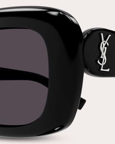 Designed with a unique pillowed effect, these Saint Laurent sunglasses feature slim rectangular frames outfitted with total light-blocking lenses. Signature logos on the temples add iconic, elevated appeal to this contemporary pair. Silvertone logo detail (temples) Pillowed frames Frames: 100% recycled acetate 100% UV protection California Prop 65 Wipe with soft cloth Made in Italy Measurements Lens width: 53mm Bridge width: 12mm Temple length: 140mm | Saint Laurent Women's Pillowed Rectangular Signature Logos, Saint Laurent Sunglasses, Rectangular Sunglasses, Signature Logo, Solid Black, Uv Protection, Design Details, Saint Laurent, Silver Tone