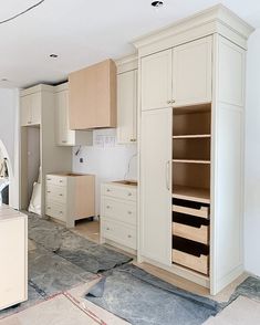 an unfinished kitchen with white cabinets and drawers