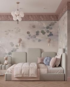 a bed sitting in the middle of a bedroom next to a wall with flowers on it