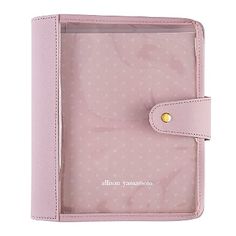 a pink passport case with an embellishment on the front and side, open